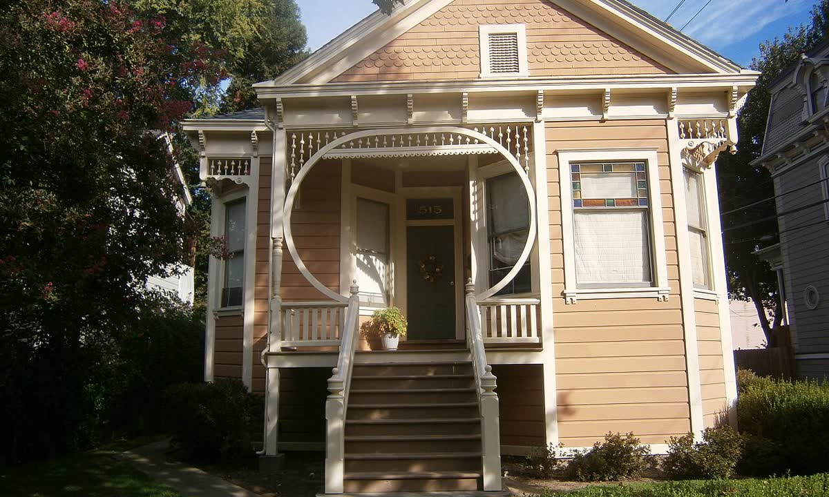 Victorian cottage with steps up to a raised porch in the Alkali Flat West Historic District
